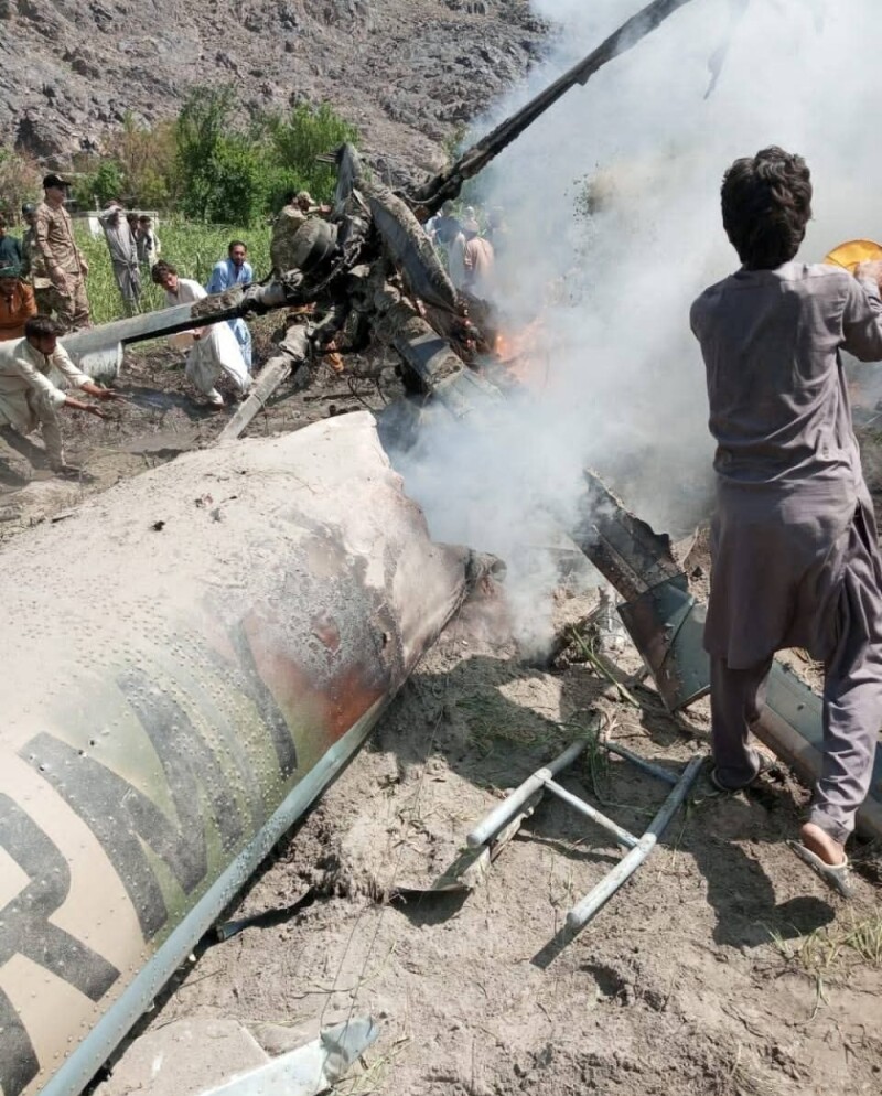   People and security personnel are trying to put out fire at the site of helicopter crash in Diamer,GB, on September 1, 2025. Photo: GB Government Spokesperson Faizullah Faraq  