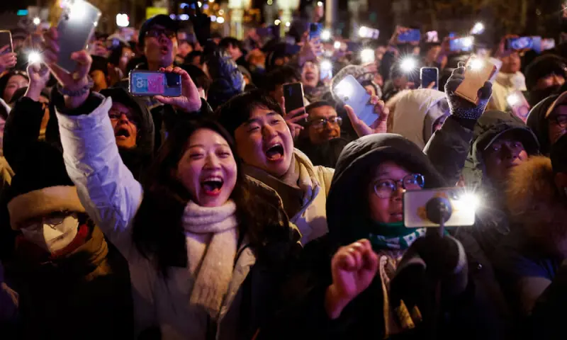 People holding flashlights celebrate after midnight as the new year begins in Seoul, South Korea. Photo: Reuters