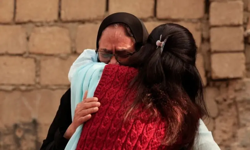 A woman is comforted as she mourns six missing family members who were there shopping for a wedding ceremony, following a massive fire that broke out in the Gul Plaza Shopping Mall in Karachi on January 19, 2026. Photo: Reuters
