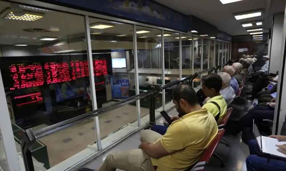 Iranian men monitor the stock market at the Tehran Stock Exchange on July 1, 2019 File Photo: AFP