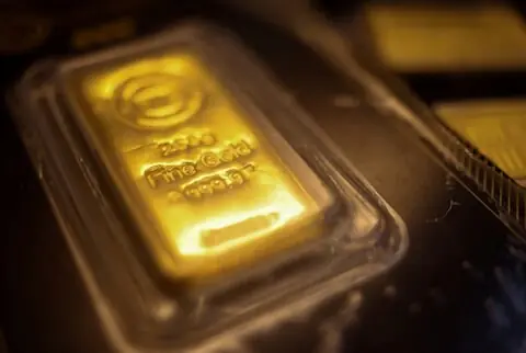 Gold set for weekly loss on stronger dollar, rate-hike bets
