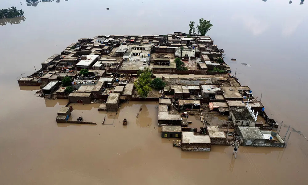 An aerial view shows residential buildings partially submerged in floodwaters after heavy monsoon rains induced a rise in the water level of the River Ravi in Pakistan&rsquo;s Muridke on July 27, 2026. Photo: AFP