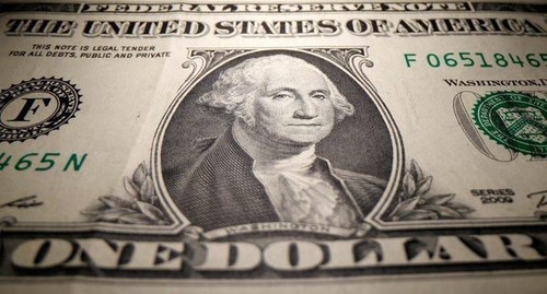 Dollar holds gains as traders trim short bets; data boosts yuan