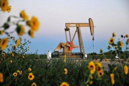 Oil prices hold gains after U.S. crude inventory draw