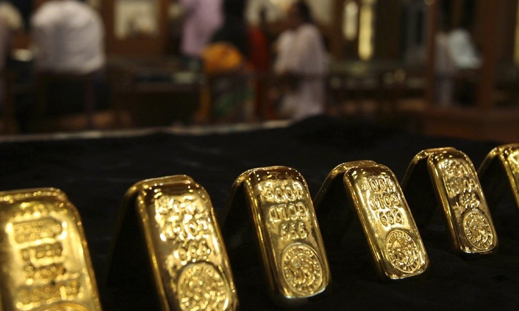 Gold slips on firmer dollar, vaccine rollout