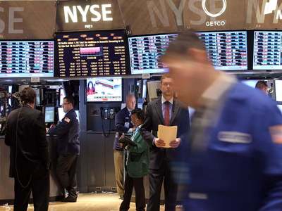 Wall Street falls as stimulus rally cools, Tesla hits record high