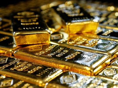 Gold buckles under firmer dollar, bond yields ahead of payroll data