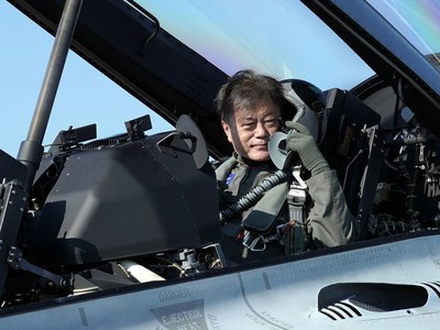 Arriving in fighter jet, South Korea's Moon urges defence industry growth