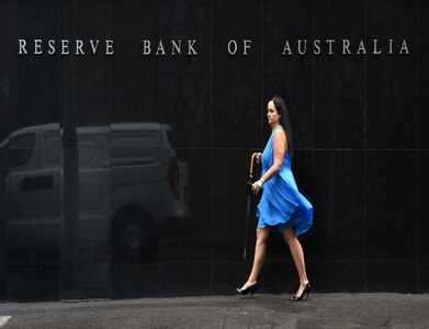 Australia's central bank ends bond buying, in no rush to hike rates