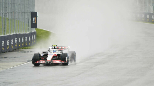 Schumacher and Zhou celebrating in the rain