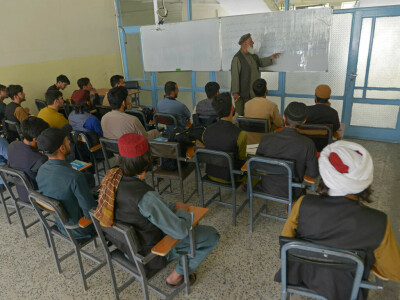 Taliban fighters swap arms for books as hundreds return to school