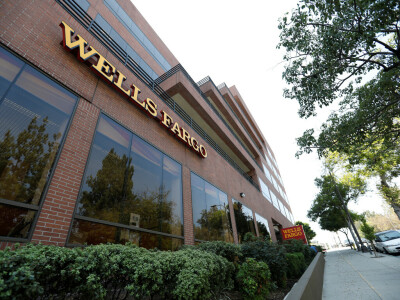 Wells Fargo profit falls 50% on higher reserves, costs