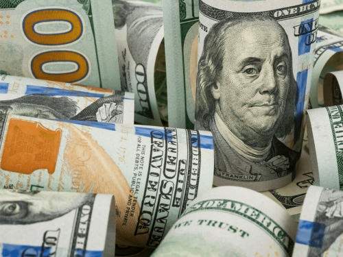 Dollar tracks Treasury yields lower as Fed stays on hold