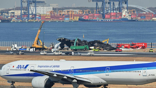 Plane wreckage being cleared from Tokyo airport after collision