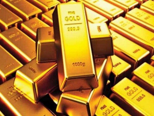 Gold ticks lower as dollar firms, traders await more US data