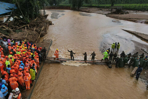 Indian soldiers building metal bridge to marooned area in Kerala landslides