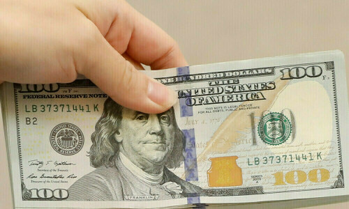 Dollar drifts higher at end of volatile week of Trump backflips