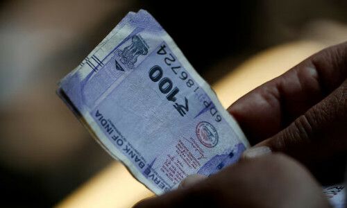 Rupee slips, volatility expectations unruffled by looming tariff deadline