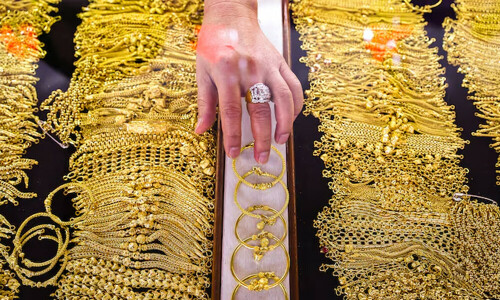 Gold at over one-month high as weak dollar, bond yields lift appeal