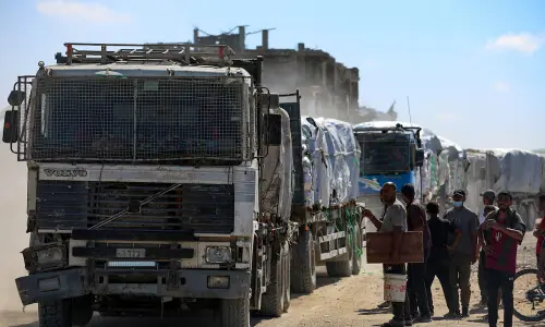 Aid trucks roll into Gaza as dispute over hostage bodies is paused
