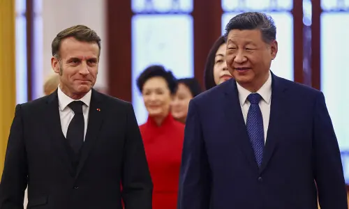 Flanked by business leaders, Macron meets Xi as EU prepares tougher trade rules