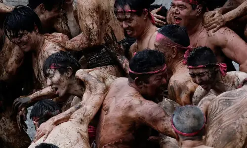 &lsquo;Blessed rain&rsquo;: Japanese men in loincloths wrestle in harvest rite