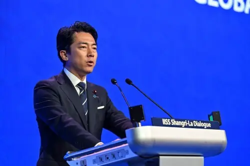 Japan rejects 'new militarism', accuses China of rapidly arming
