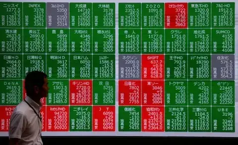 Asian stocks edge higher, rupiah down