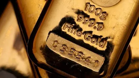 Gold eases on firm dollar; spotlight on US inflation data