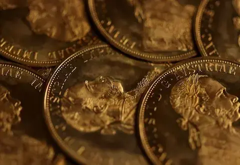 Gold gains on softer dollar, but heads for weekly fall