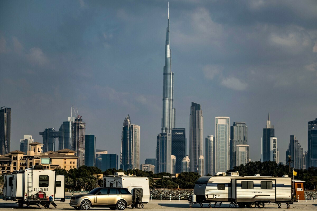  Camper vehicles are pictured with a backdrop of the Dubai skyline including Burj Khalifah, the world&rsquo;s tallest structure at 829.8 metres, on January 31, 2025. (Photo: AFP 