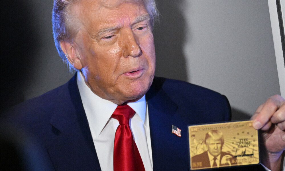 US President Donald Trump holds the $5 million dollar Gold Card as he speaks to reporters while in flight on board Air Force One, en route to Miami, Florida on April 3, 2025. Photo: AFP