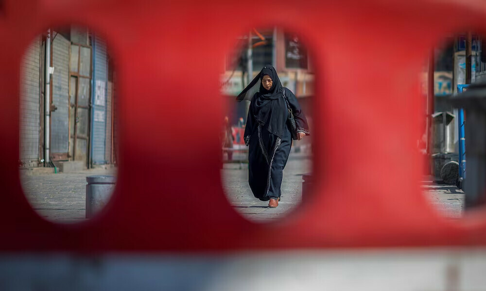  A Kashmiri woman walking on a street is seen through a road blockade, following an attack on tourists near Pahalgam in south Kashmir, in Srinagar. Photo: Reuters 
