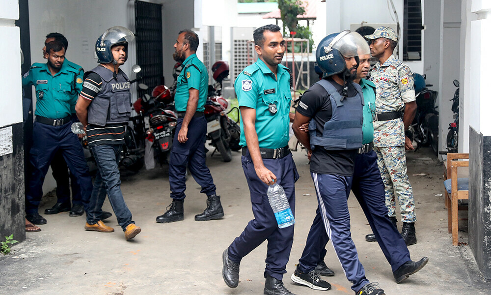 Police personnel escort detained policemen charged with crimes against humanity, to the International Crimes Tribunal (ICT) court in Dhaka on May 25, 2025. Photo: AFP