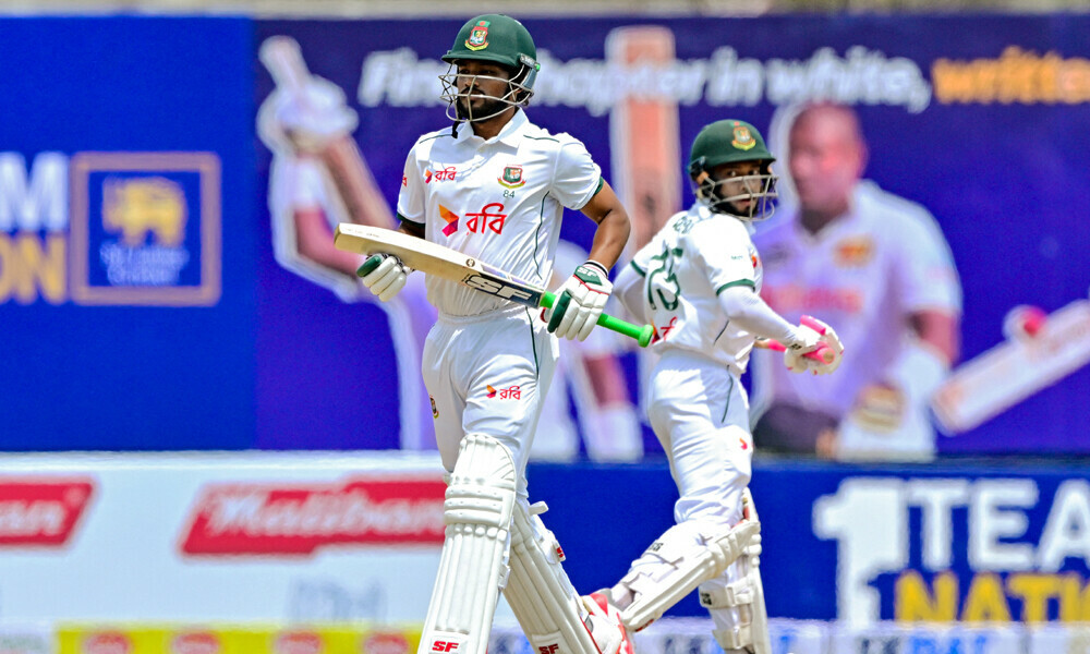 Bangladesh’s captain Najmul Hossain Shanto (L) and Mushfiqur Rahim run between the wickets during the first day of the first Test cricket match between Sri Lanka and Bangladesh at the Galle International Cricket Stadium in Galle on June 17, 2025. Photo: AFP