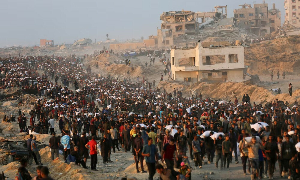 Palestinians gather to receive aid supplies in Beit Lahia, in the northern Gaza Strip, June 17, 2025. REUTERS