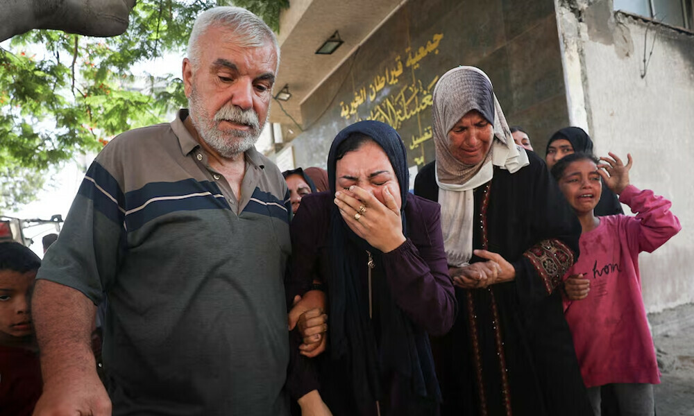 Mourners react during the funeral of Palestinians who were killed by Israeli fire while trying to receive aid in central Gaza Strip, according to the Gaza Health Ministry, at Al-Shifa hospital, in Gaza City, June 24, 2025. REUTERS