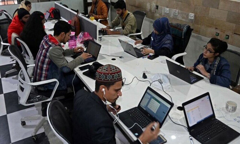 In this picture taken on January 8, 2022, employees of a call centre talk with customers in Lahore. AFP/File