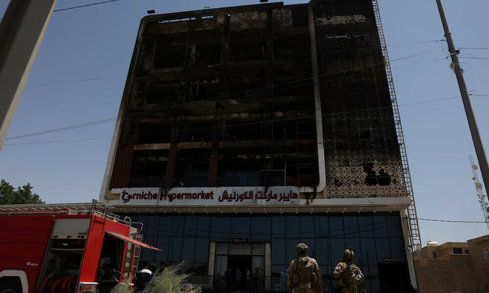 A fire truck stands next to the wreckage of a five-storey shopping center, after a massive overnight fire killed dozens of people, in al-Kut, Wasit province, Iraq, July 17, 2025. Photo: Reuters