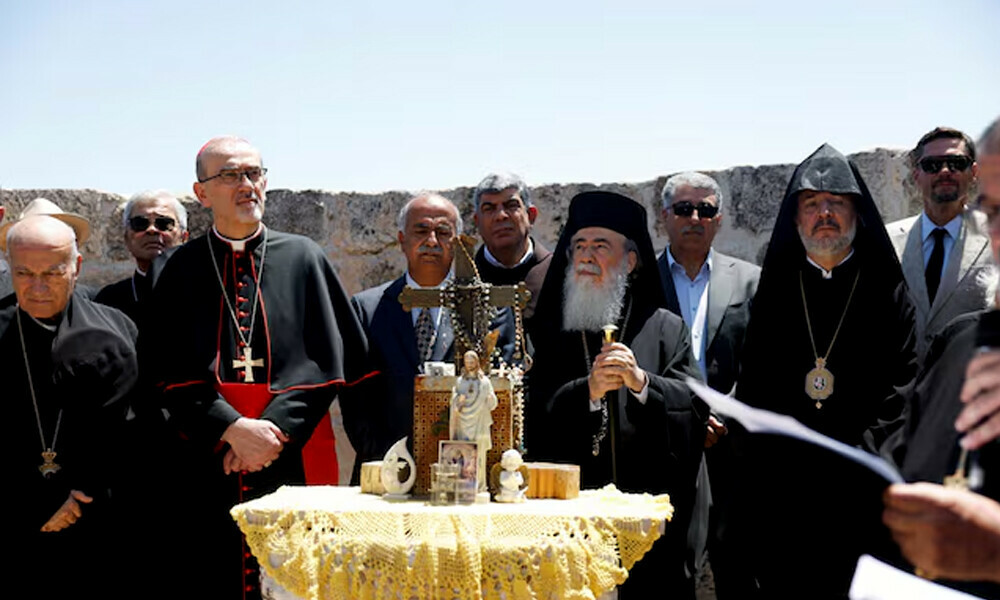 Latin Patriarch in Jerusalem, Pierbattista Pizzaballa, and Greek Orthodox patriarch of Jerusalem, Theophilos III, look on during the visit to the town of Taybeh, a Christian village in the Israeli-occupied West Bank, following settler attacks, July 14, 2025. REUTERS