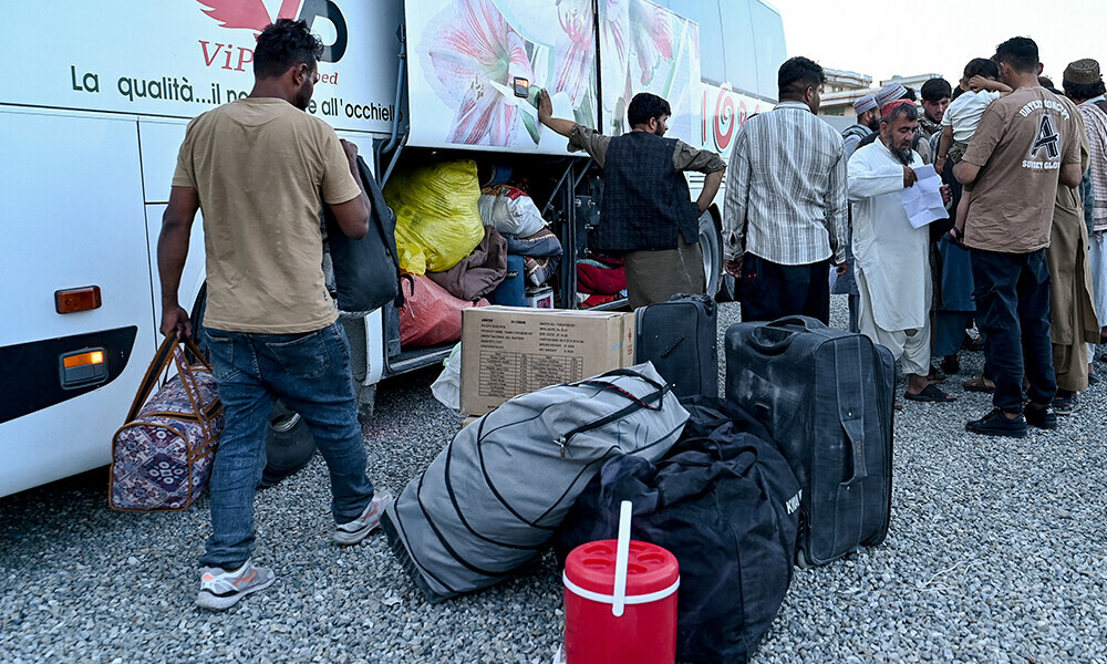 Afghan refugees deported from Iran, wait to board a bus at a makeshift camp in Kabul on July 16, 2025. Photo: AFP