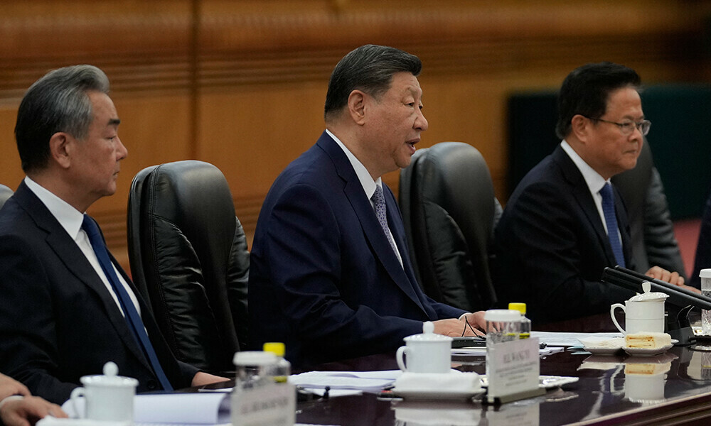 Chinese President Xi Jinping (C) speaks as Foreign Minister Wang Yi (L) looks on during the opening remarks of the EU-China summit at the Great Hall of the People in Beijing on July 24, 2025. Photo: AFP