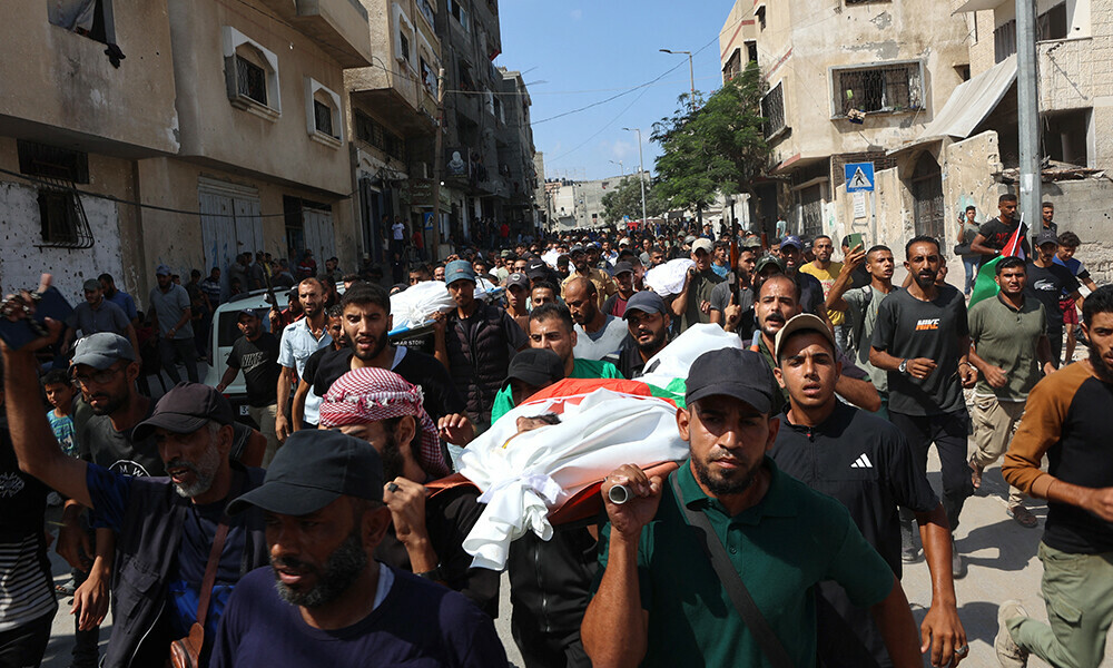 Mourners carry the body of a Palestinian, killed the night before in an Israeli strike, during their funeral in Gaza City on July 29, 2025. Photo: AFP