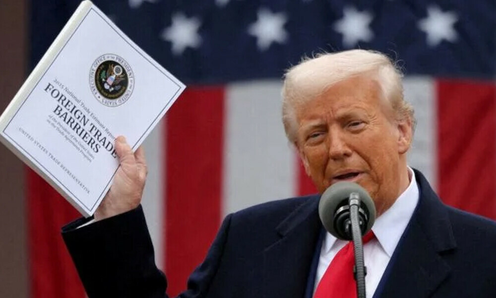 US President Donald Trump holds a “Foreign Trade Barriers” document as he delivers remarks on tariffs. Photo: Reuters