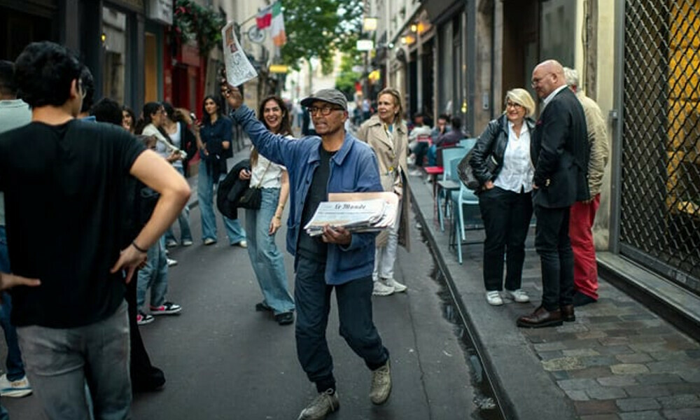 Ali Akbar, a Pakistani-born newspaper hawker, can be seen at work on the streets of Paris, France, in this undated image. — New York Times Ali Akbar, a Pakistani-born newspaper hawker, can be seen at work on the streets of Paris, France, in this undated image. — New York Times