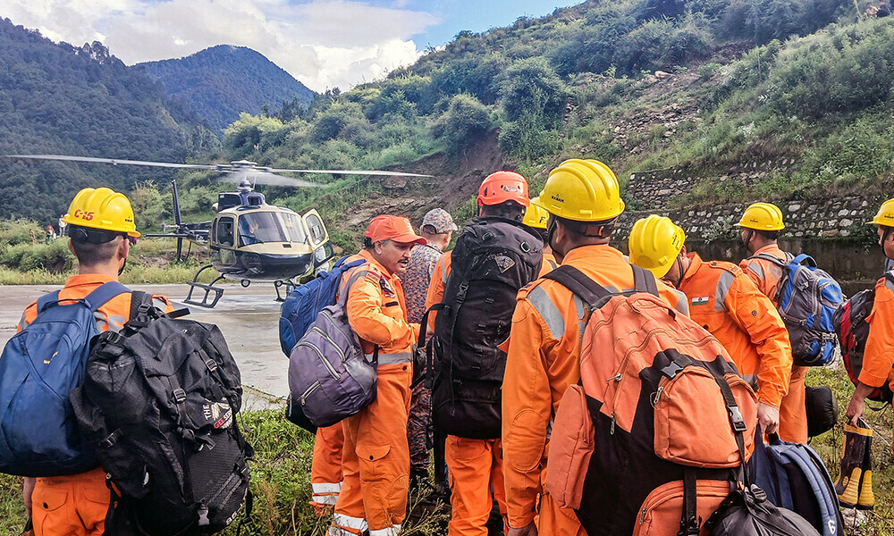 Relief personnel from the National Disaster Response Force (NDRF) and State Disaster Response Force (SDRF) of India&rsquo;s Uttarakhand state prepare to board a helicopter at a village near Uttarkashi on August 6, 2025, for a search and rescue operation a day after a cloudburst caused a massive mudslide and flash floods in Uttarakhand. Photo: AFP