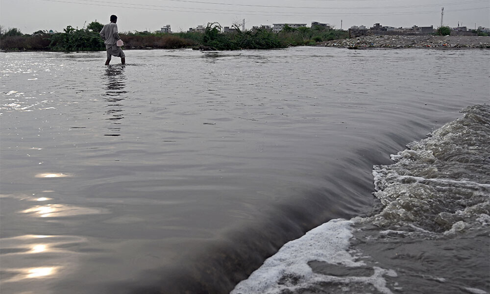 A man wades through a flooded street after heavy monsoon rains in Karachi on August 20, 2025. More than 20 people died in a fresh spell of deadly monsoon rain in Pakistan, National Disaster Management Agency (NDMA) said on August 20. Photo AFP