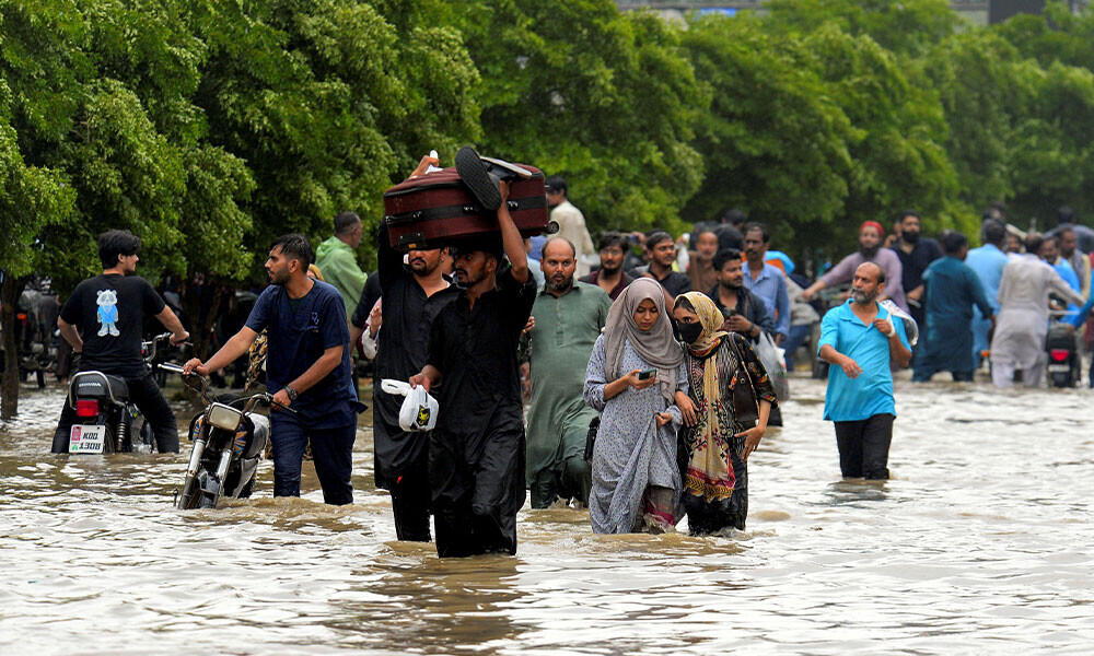 People wade through a flooded road after the monsoon rain in Karachi, Pakistan, August 19, 2025. Photo Reuters