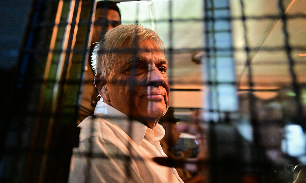 Sri Lanka&rsquo;s former president Ranil Wickremesinghe looks on as he sits in a prison bus in Colombo on August 22, 2025, after a magistrate ordered him to be held in remand custody till August 26, 2025, following allegations that he misused state funds to travel to Britain in 2023. Photo: AFP