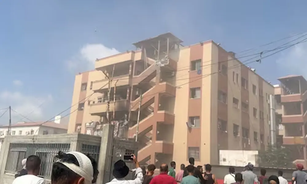 People walk at the site of Israeli strikes on Nasser hospital where Palestinian cameraman Hussam al-Masri, who was a contractor for Reuters, was killed along with other journalists and people, in Khan Younis in the southern Gaza Strip in this still image taken from video, August 25, 2025. REUTERS